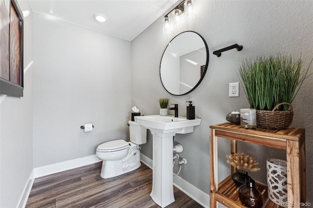 bathroom featuring hardwood / wood-style floors and toilet