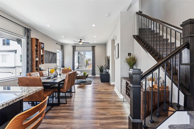 dining space featuring ceiling fan and dark hardwood / wood-style flooring