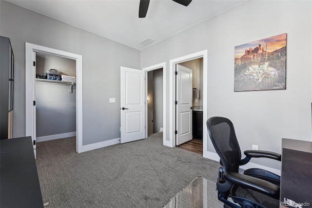 office area with dark colored carpet and ceiling fan