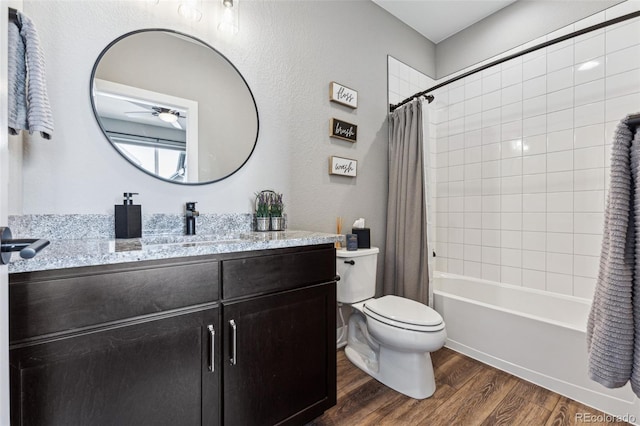 full bathroom with shower / tub combo with curtain, wood-type flooring, toilet, and vanity