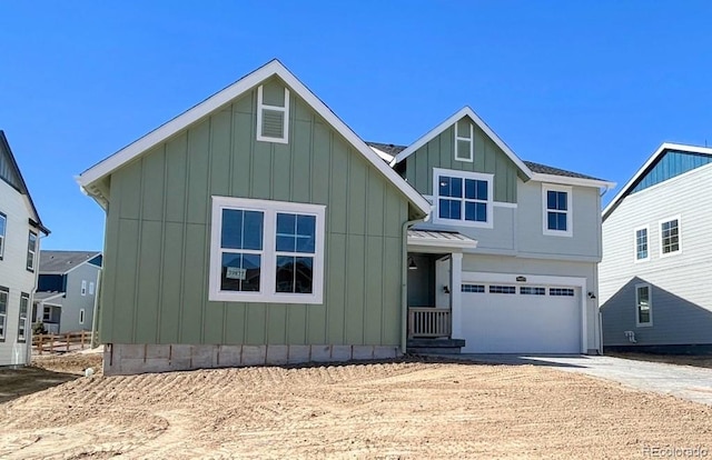 view of front of home with board and batten siding, driveway, and an attached garage