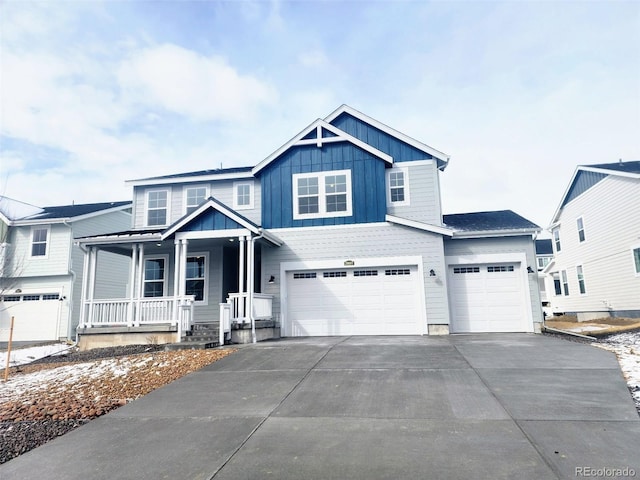 view of front of property featuring covered porch, board and batten siding, driveway, and a garage