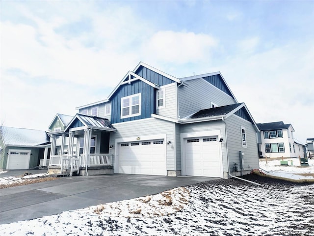 view of front facade with covered porch, board and batten siding, concrete driveway, and an attached garage