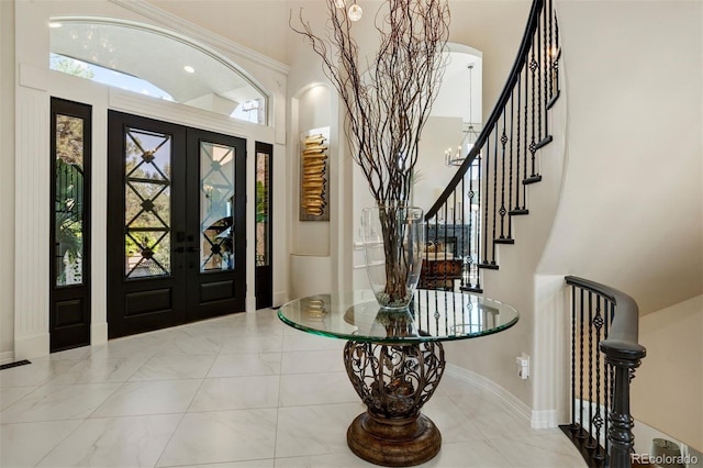 entrance foyer with a towering ceiling and french doors