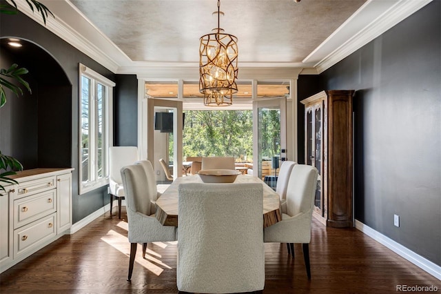 dining room featuring ornamental molding, dark hardwood / wood-style floors, and a chandelier