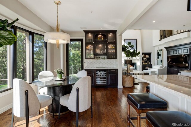 dining space with dark hardwood / wood-style flooring and wine cooler