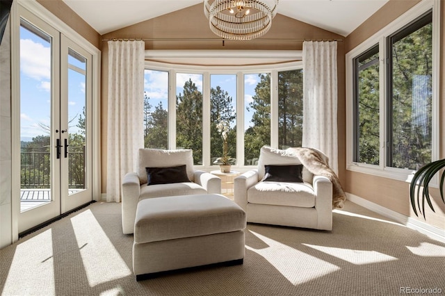 sunroom / solarium featuring a healthy amount of sunlight, vaulted ceiling, and french doors