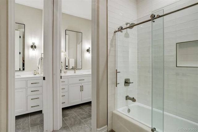 bathroom featuring bath / shower combo with glass door and vanity