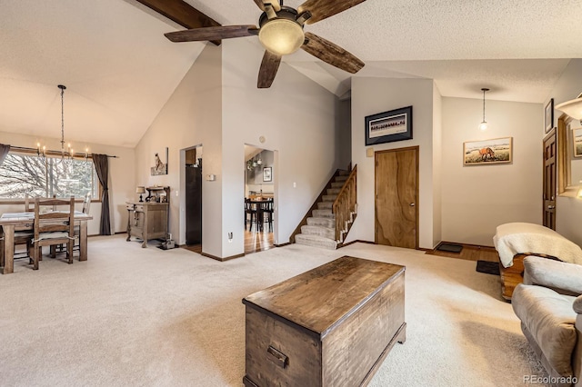 living room featuring stairs, a chandelier, light carpet, baseboards, and high vaulted ceiling