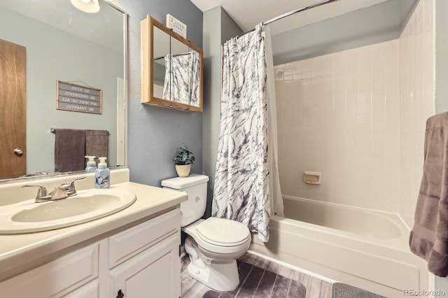 full bathroom featuring toilet, shower / bath combination with curtain, and vanity