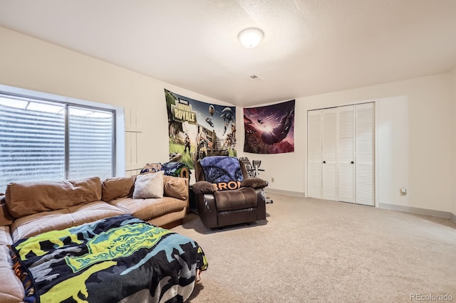 carpeted living room with baseboards