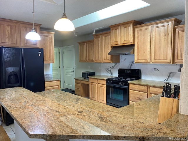 kitchen with light tile patterned flooring, pendant lighting, and black appliances