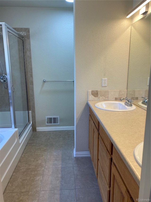 bathroom with dual vanity, independent shower and bath, and tile patterned flooring