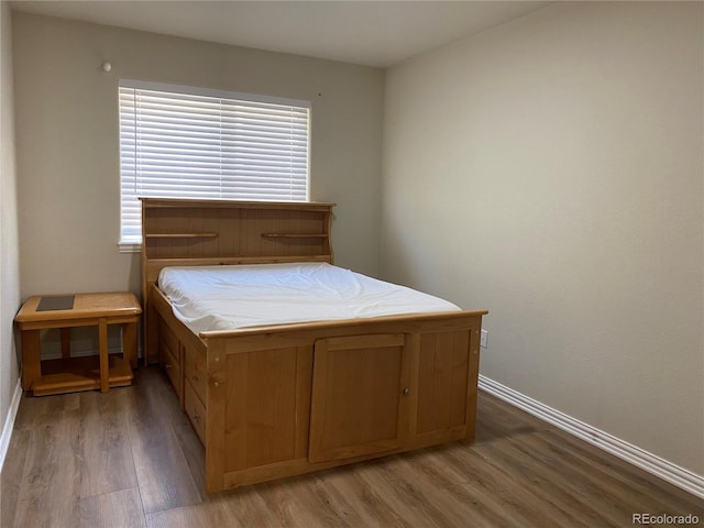 bedroom featuring light wood-type flooring and baseboards