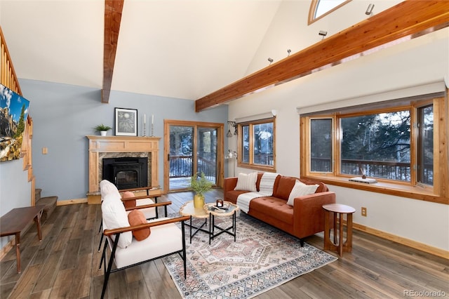 living room featuring dark wood-type flooring, a fireplace, beam ceiling, and high vaulted ceiling