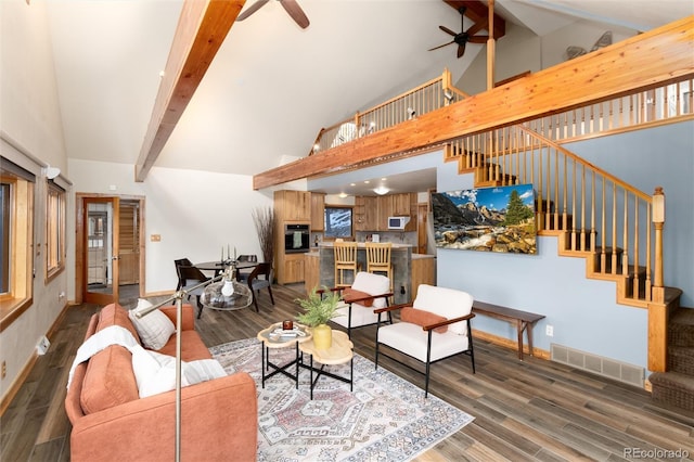 living room featuring ceiling fan, dark hardwood / wood-style flooring, high vaulted ceiling, and beam ceiling