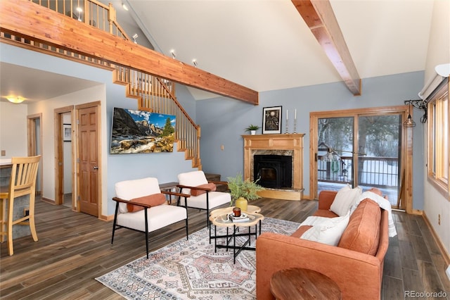 living room featuring beamed ceiling, a high end fireplace, dark hardwood / wood-style floors, and high vaulted ceiling