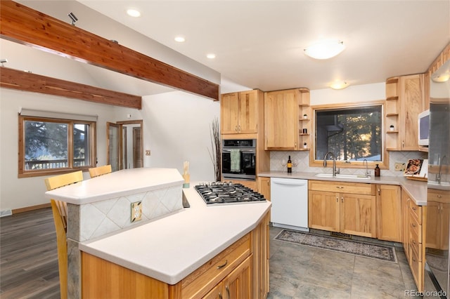 kitchen with sink, decorative backsplash, stainless steel appliances, light brown cabinets, and beam ceiling