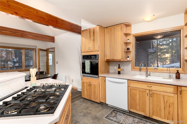 kitchen with sink, gas stovetop, dishwasher, black oven, and decorative backsplash