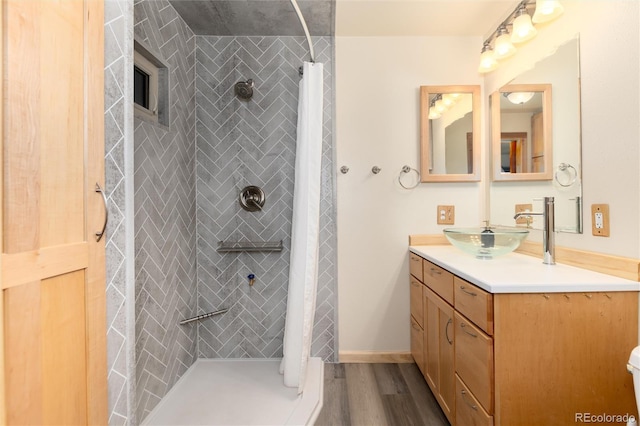 bathroom featuring vanity, hardwood / wood-style floors, and walk in shower