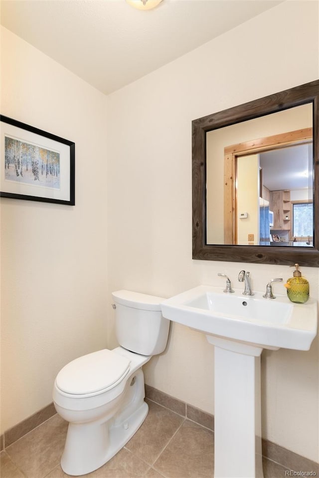 bathroom with sink, tile patterned floors, and toilet