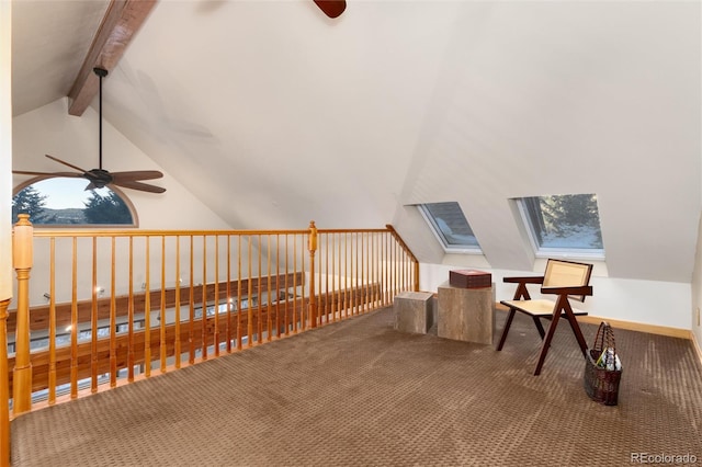 sitting room featuring carpet floors, vaulted ceiling with beams, and ceiling fan