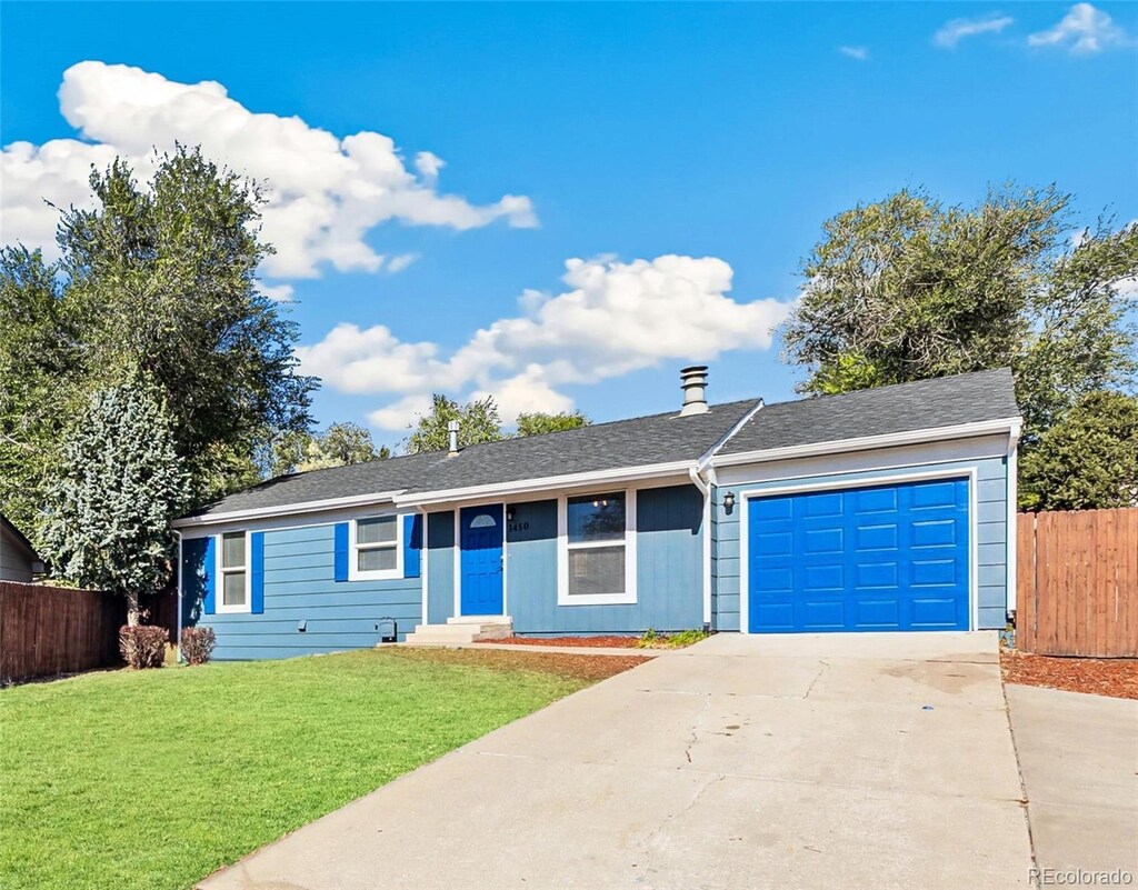 single story home featuring a garage and a front lawn