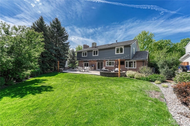 10289 E Berry Dr, Greenwood Village, CO 80111 - rear view of house featuring a patio, a chimney, a yard, and brick siding