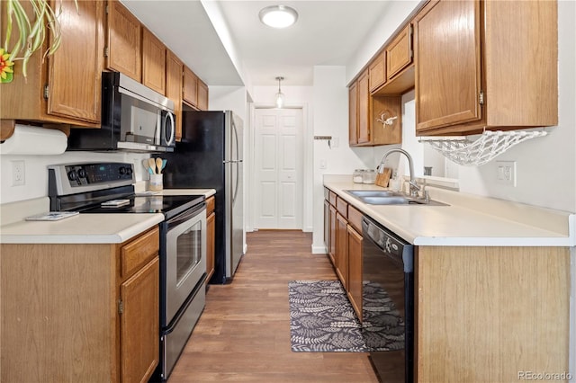 kitchen featuring wood-type flooring, appliances with stainless steel finishes, and sink