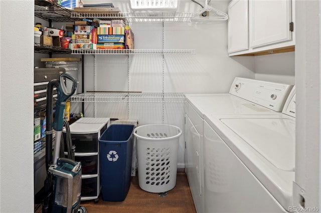 clothes washing area with dark hardwood / wood-style flooring, cabinets, and independent washer and dryer