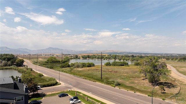 drone / aerial view with a water and mountain view