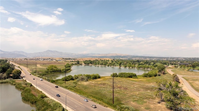 birds eye view of property with a water and mountain view