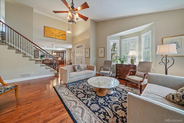 4545 S Monaco St Unit 243, Denver, CO 80237 - living room featuring wood finished floors, stairway, baseboards, and a ceiling fan