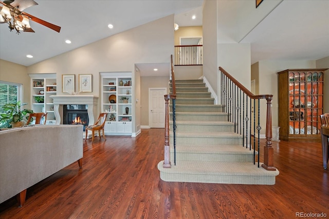 4545 S Monaco St Unit 243, Denver, CO 80237 - stairs featuring a glass covered fireplace, a ceiling fan, wood finished floors, recessed lighting, and high vaulted ceiling