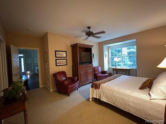 4545 S Monaco St Unit 243, Denver, CO 80237 - bedroom with light carpet and ceiling fan