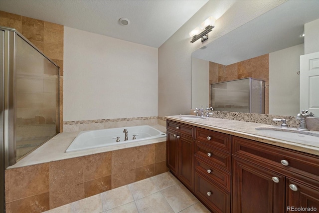 4545 S Monaco St Unit 243, Denver, CO 80237 - full bathroom with a garden tub, double vanity, a shower stall, and tile patterned floors