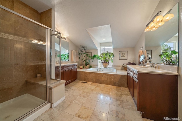 4545 S Monaco St Unit 243, Denver, CO 80237 - full bathroom featuring a shower stall, two vanities, a garden tub, tile patterned flooring, and vaulted ceiling