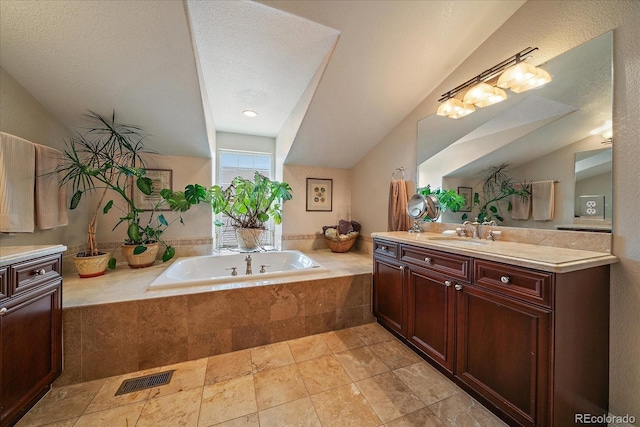 4545 S Monaco St Unit 243, Denver, CO 80237 - bathroom featuring vanity, a garden tub, and vaulted ceiling