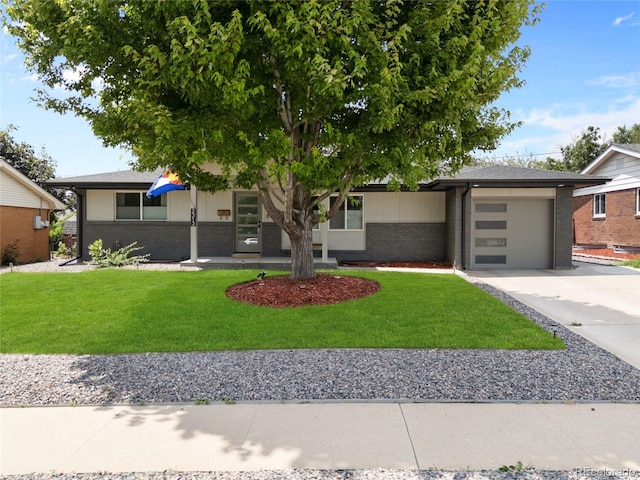2313 S Raleigh St, Denver, CO 80219 - view of front of property with brick siding, driveway, an attached garage, and a front yard