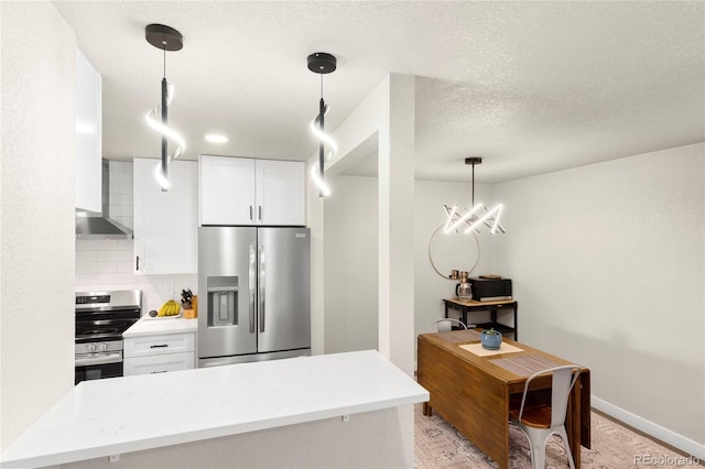 2313 S Raleigh St, Denver, CO 80219 - kitchen featuring appliances with stainless steel finishes, white cabinets, decorative backsplash, hanging light fixtures, and light wood-style floors