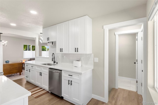 2313 S Raleigh St, Denver, CO 80219 - kitchen featuring dishwasher, tasteful backsplash, light countertops, white cabinets, and recessed lighting