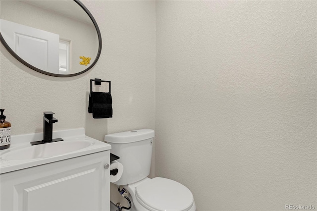 2313 S Raleigh St, Denver, CO 80219 - bathroom featuring a textured wall and vanity