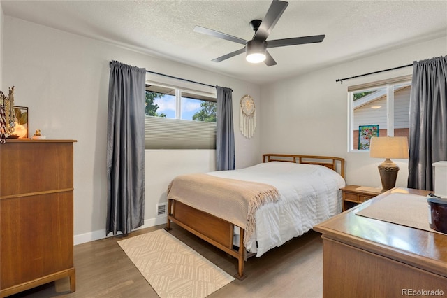 2313 S Raleigh St, Denver, CO 80219 - bedroom featuring wood finished floors, a textured ceiling, and a ceiling fan