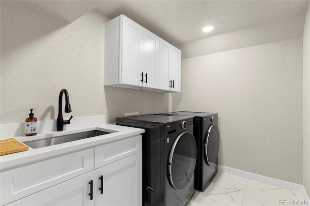 2313 S Raleigh St, Denver, CO 80219 - laundry area featuring cabinet space, washing machine and clothes dryer, light marble finish floors, and recessed lighting