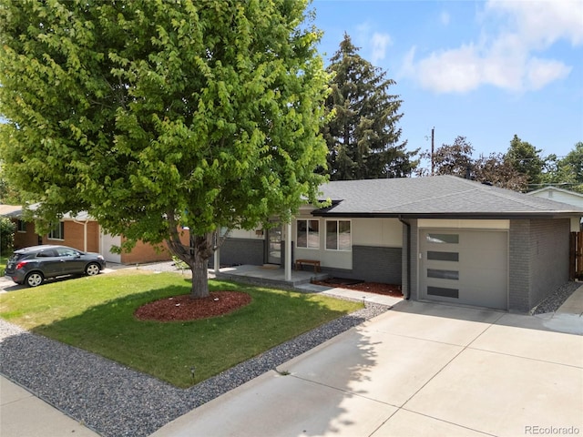 2313 S Raleigh St, Denver, CO 80219 - view of front facade featuring brick siding, a garage, a shingled roof, and a front yard