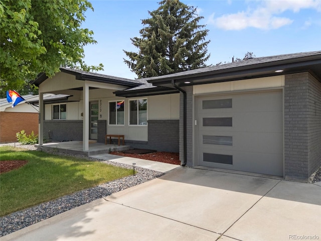 2313 S Raleigh St, Denver, CO 80219 - view of front of property featuring brick siding, driveway, a porch, and an attached garage