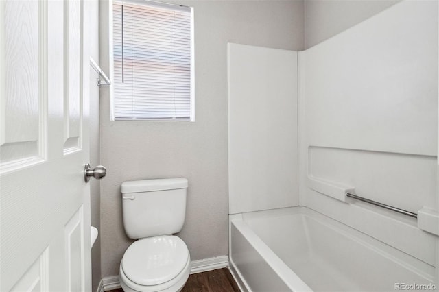 bathroom featuring shower / bathtub combination, hardwood / wood-style floors, toilet, and a wealth of natural light