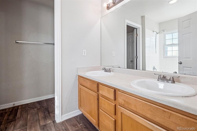 bathroom featuring vanity, a shower, and wood-type flooring