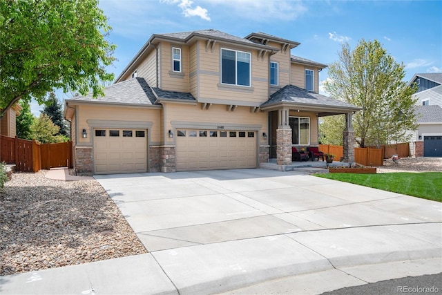 11460 W Tanforan Cir, Littleton, CO 80127 - view of front of home with fence, driveway, covered porch, and an attached garage