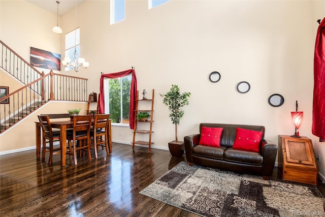 11460 W Tanforan Cir, Littleton, CO 80127 - living area featuring a high ceiling, wood finished floors, baseboards, stairs, and a chandelier